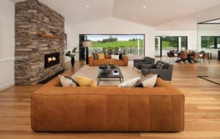 A modern living area with brick affect fireplace and comfortable seating
