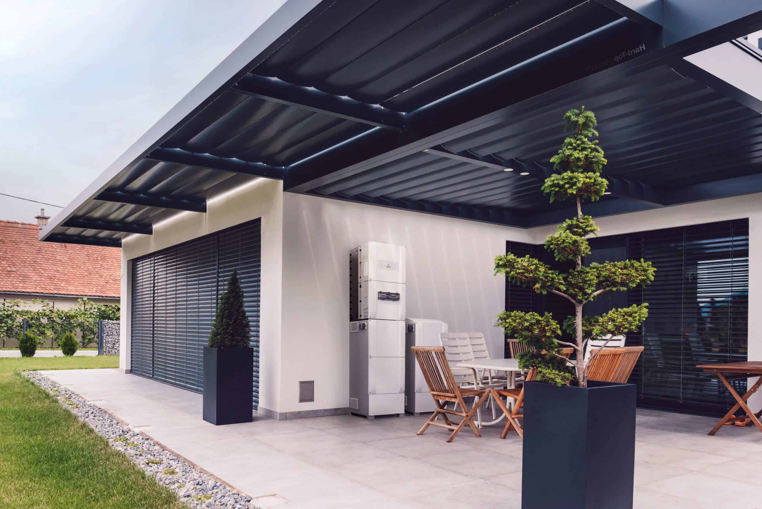 A modern home alfresco dining area with solar equipment.