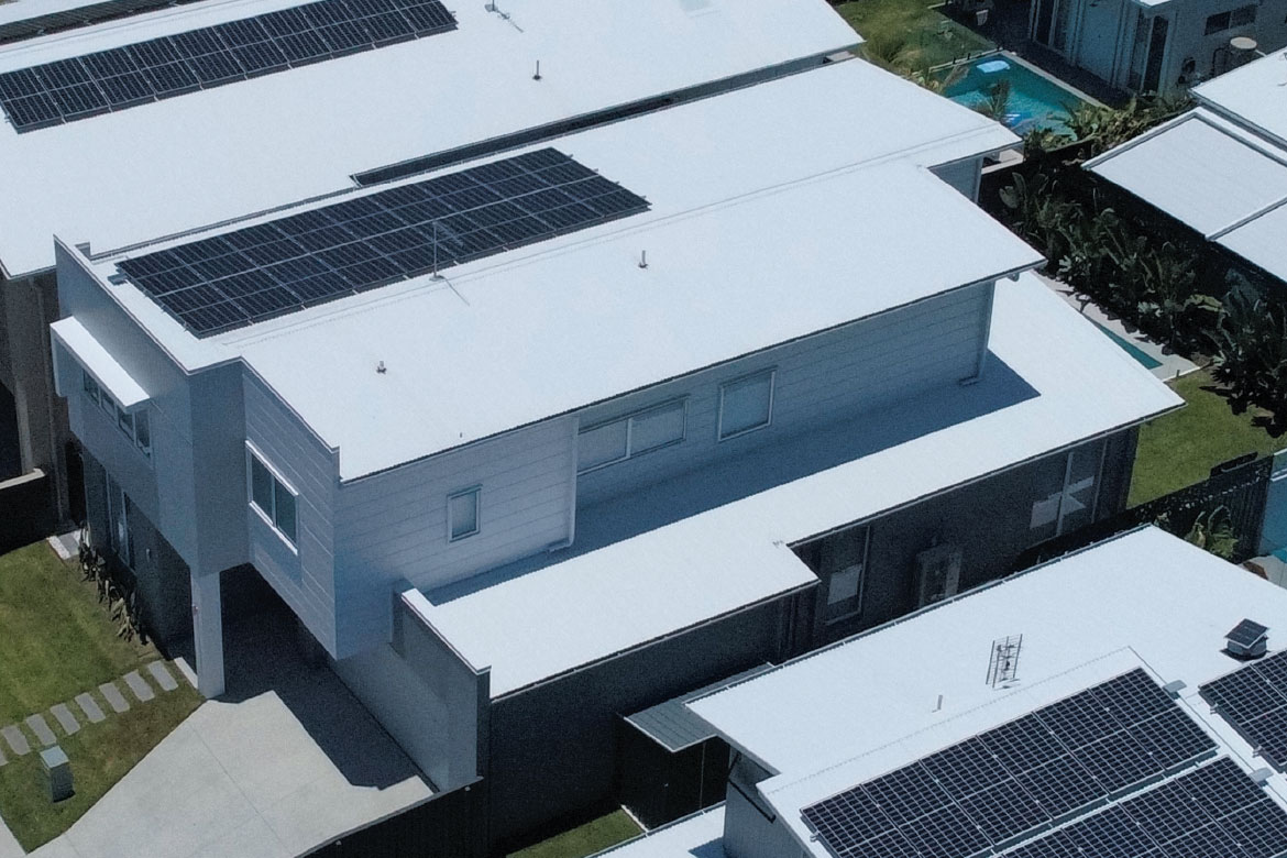 An aerial view of homes with solar panels