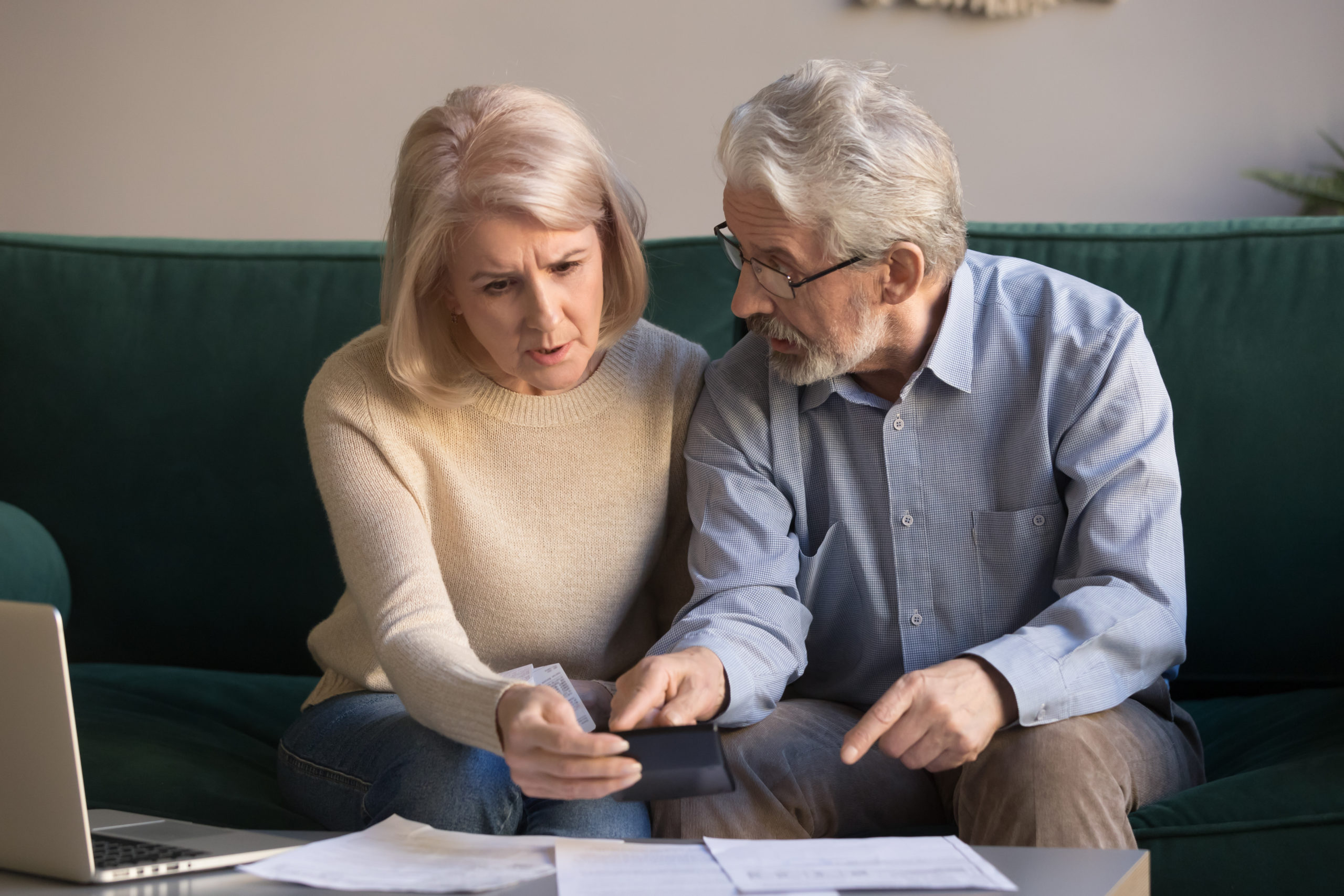 A stressed-out senior couple discussing paperwork