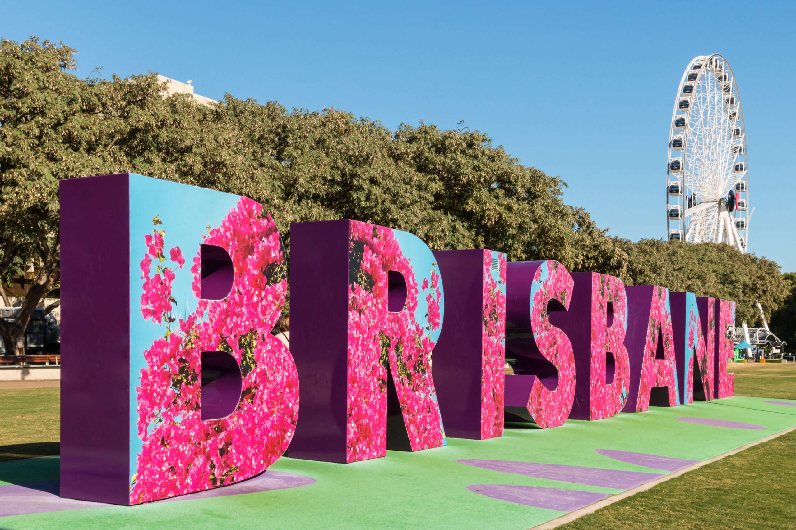 The Brisbane sign with the big wheel in the background