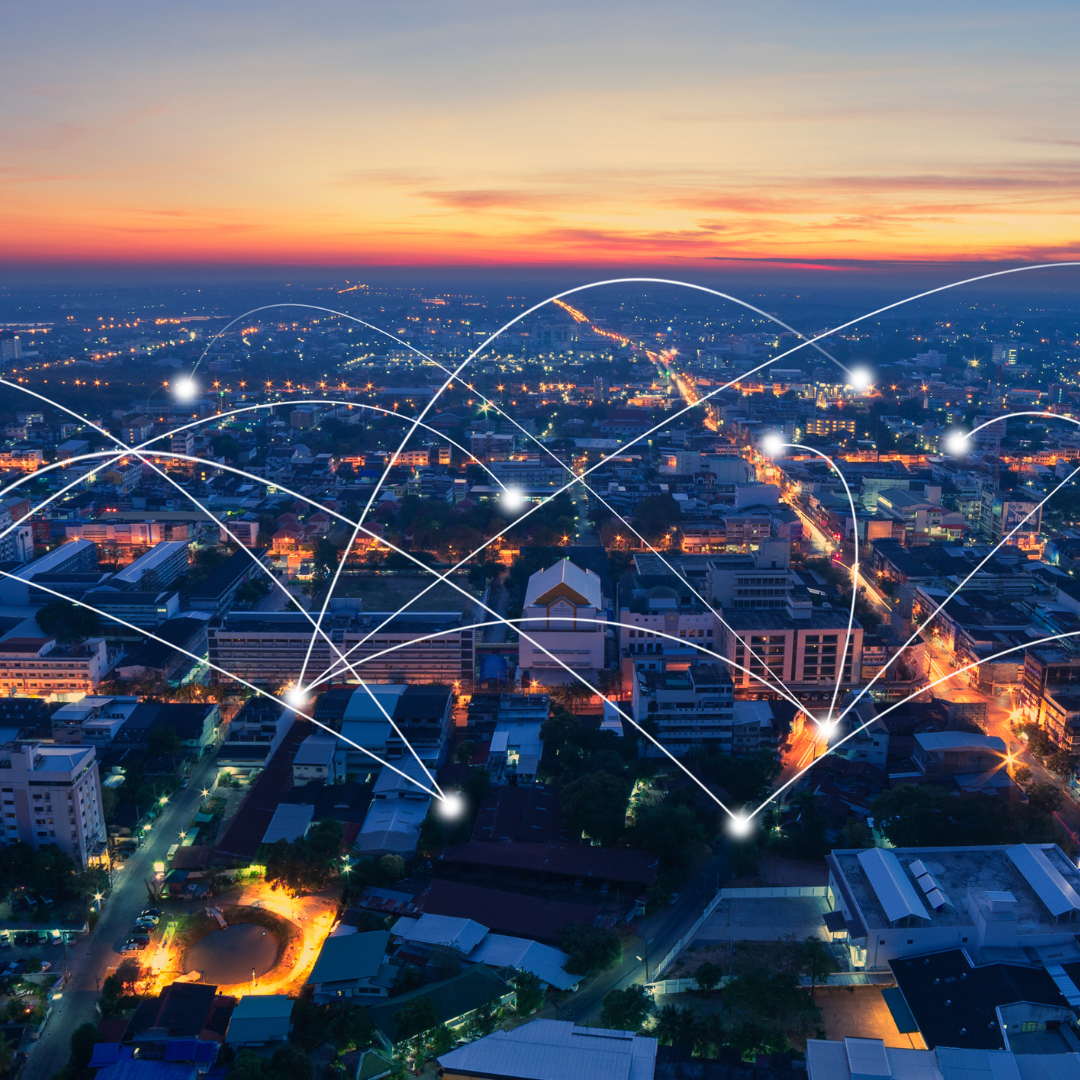 An overview of a town at sunset. Each home is connected by a white line.